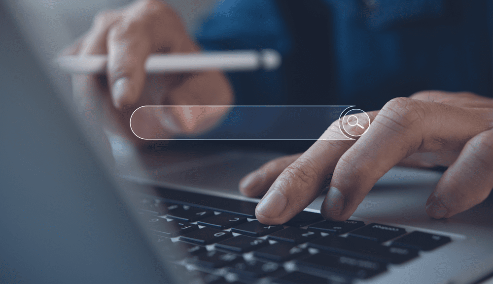 seo person typing in search words on keyboard